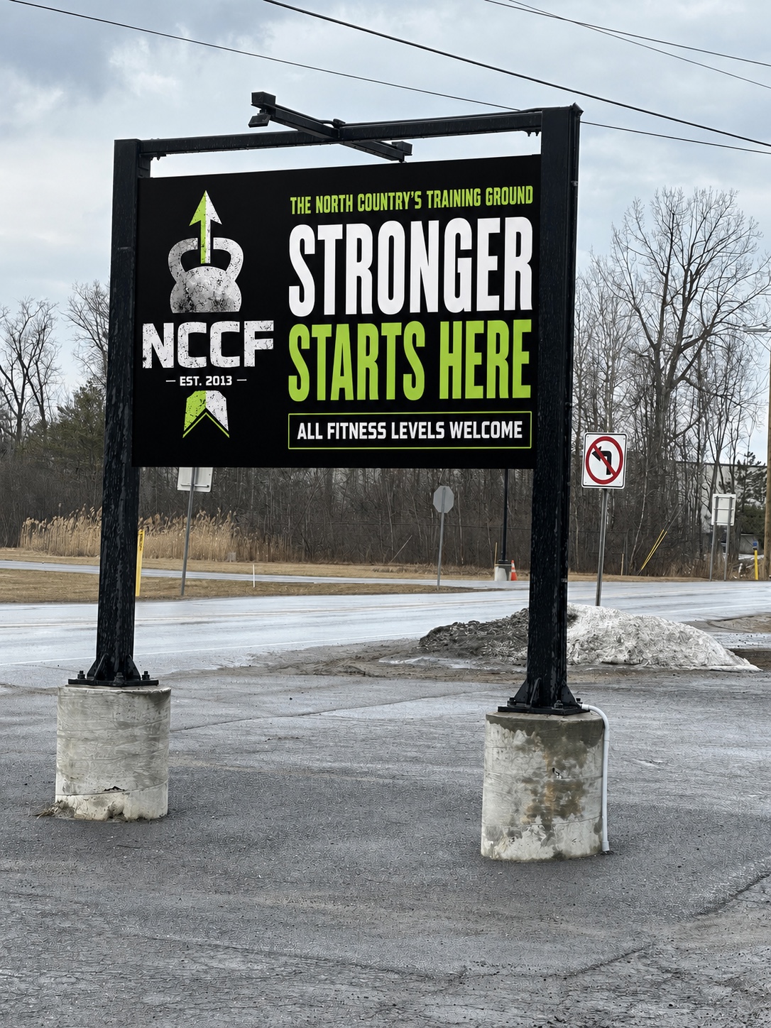 NCCF roadside sign reading Stronger Starts Here and All Fitness Levels Welcome